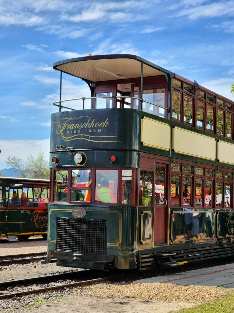 Charming two-storey tram at the popular Franschhoek wine tram station, perfect for travel and tourism.