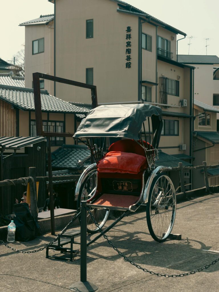 Explore the charm of Kyoto with this vintage rickshaw in a traditional setting.