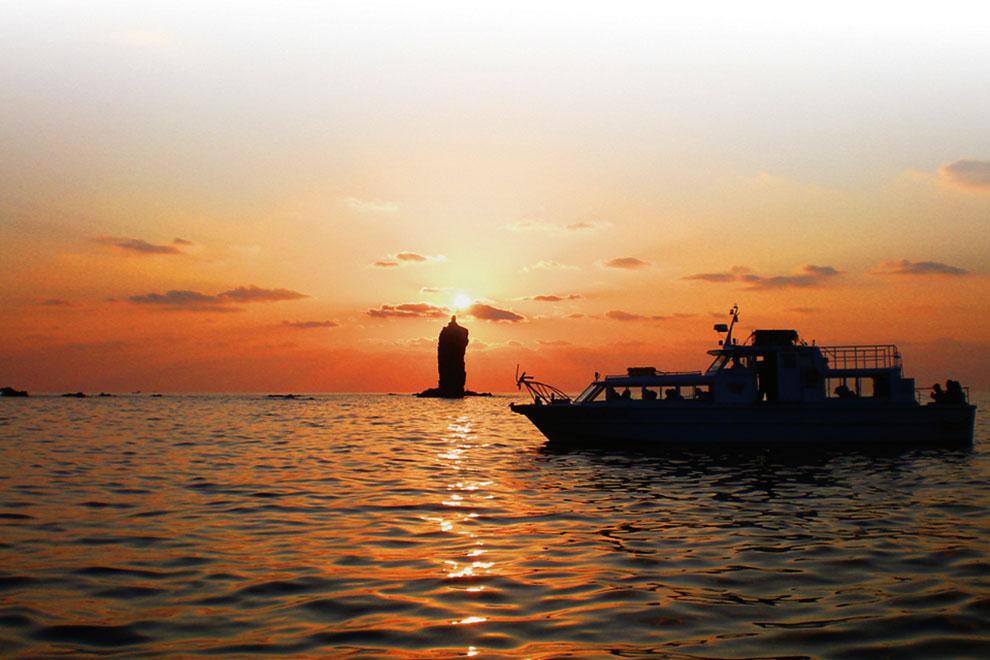 The setting sun resting on the tip of Candle Rock, Oki Islands
