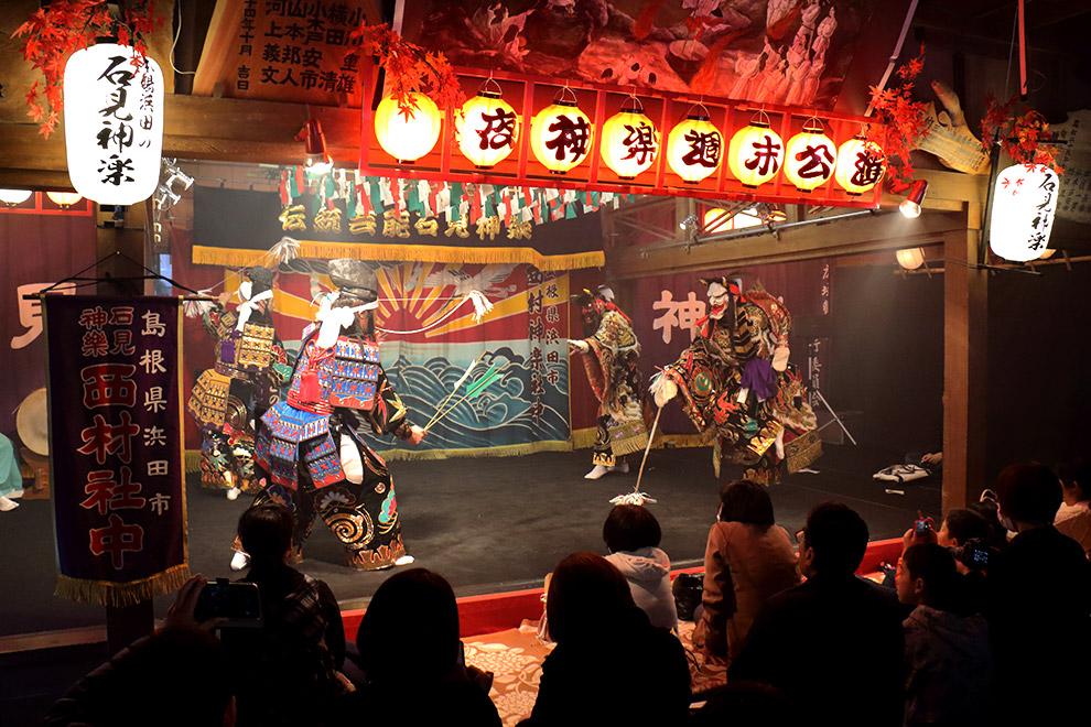 Iwami Kagura dancers performing the serpent legend in golden costumes